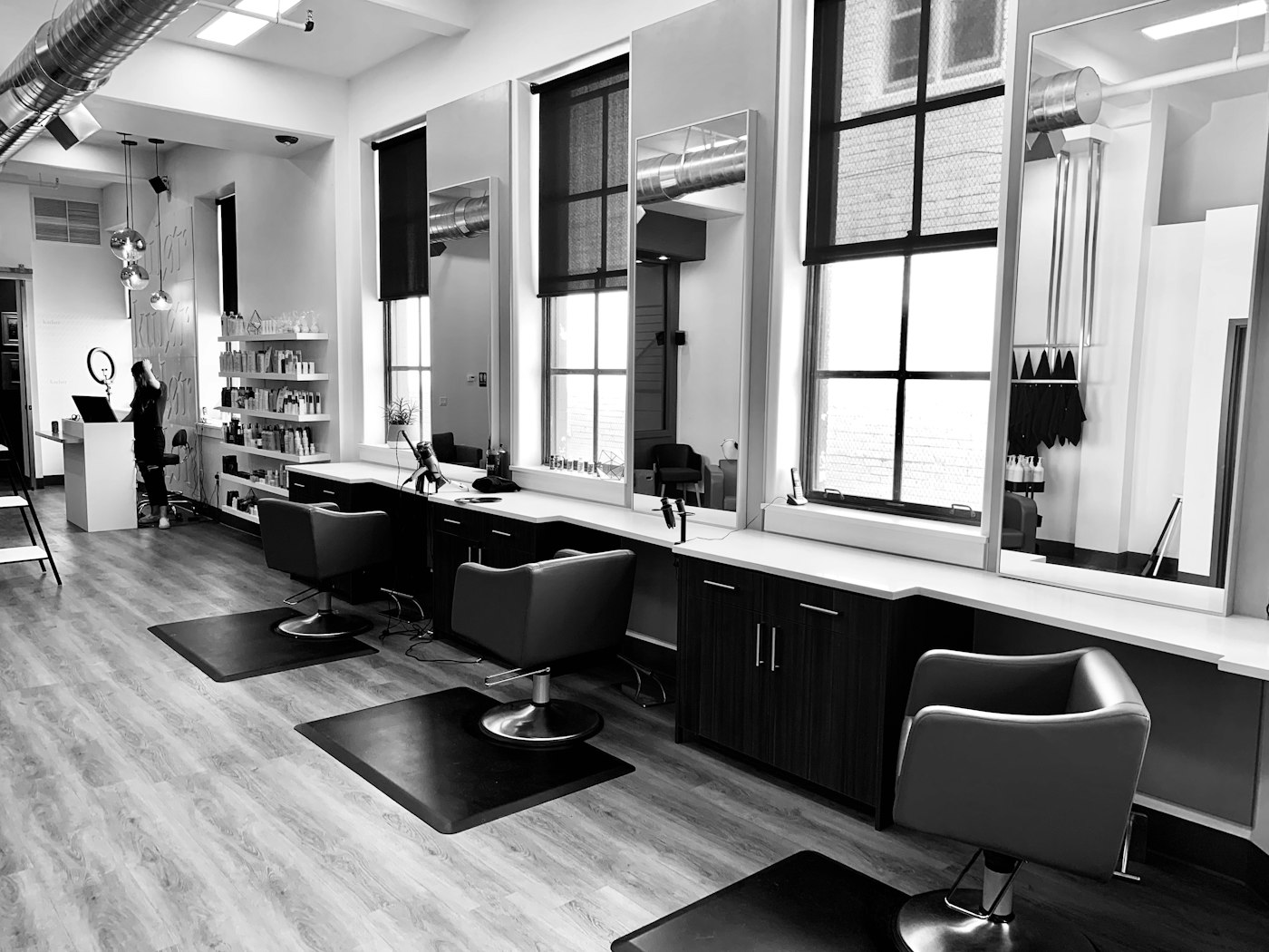 The styling stations and mirrors on the Tinka Hair salon floor