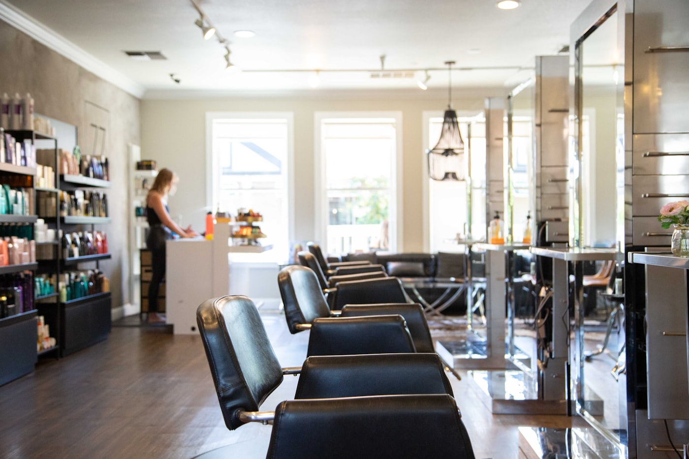 A stylist working colour through a client's hair